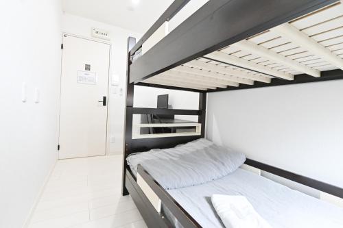 Postel nebo postele na pokoji v ubytování RUMa INN Rokugoudote