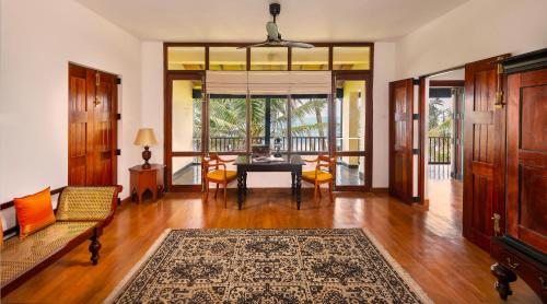 a living room with a table and chairs at Jetwing Lighthouse, A Luxury Reserve in Galle