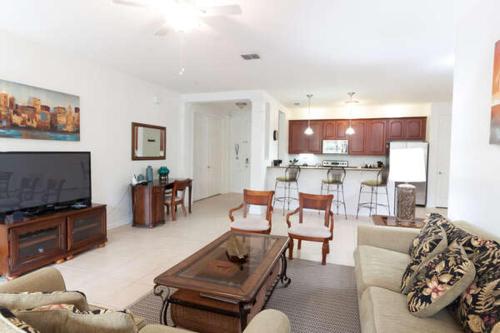 a living room with a couch and a table at 5min Universal Spacious Condo VC101 in Orlando