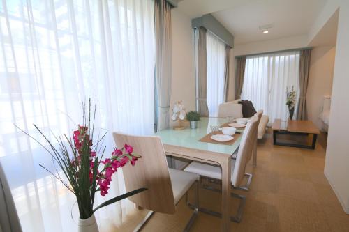 a dining room and living room with a table and chairs at NM21 Liz Osaka Castle in Osaka