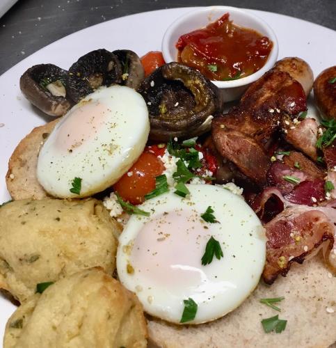 a plate of food with eggs and mushrooms at Sabo’s On Severn in Fletcher