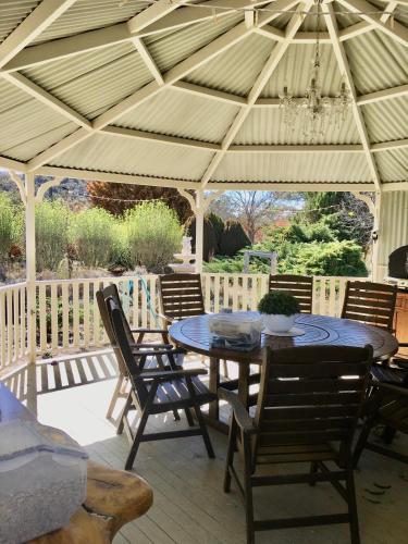 a patio with a table and chairs under a pavilion at Sabo’s On Severn in Fletcher