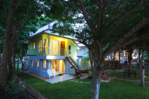 a small yellow house with a porch and a deck at Goldengold (Khaoyai) Resort & Spa in Mu Si