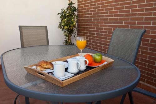 a tray of food on a table with a glass of orange juice at La City Estación in Alicante