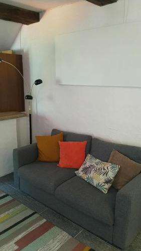 a couch with pillows on it in a living room at Residenza Americana in Someo