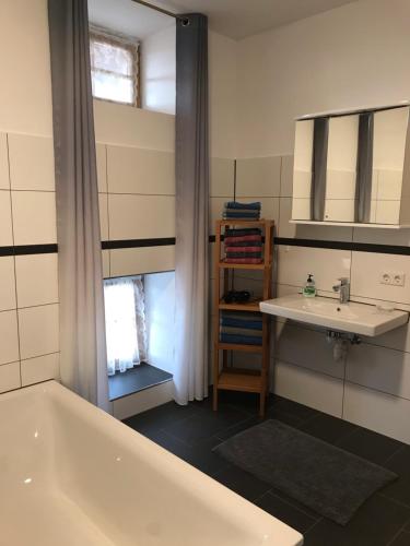 a bathroom with a bath tub and a sink at Pferdehof Dietzsch, Tittmoning in Tittmoning