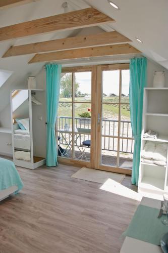 a bedroom with bunk beds and a balcony at Lavender Village in Kiemeliai