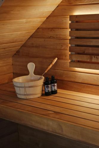 a shelf in a sauna with two bottles of essential oils at Lavender Village in Kiemeliai