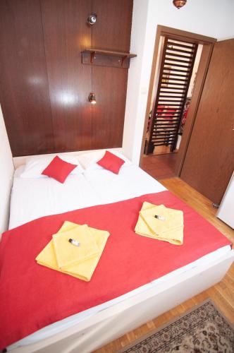 a bedroom with a bed with two pillows on it at Guest house Vila Korošec in Bovec