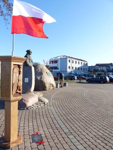 a flag on a pole on a street at Dom Żeglarza in Puck