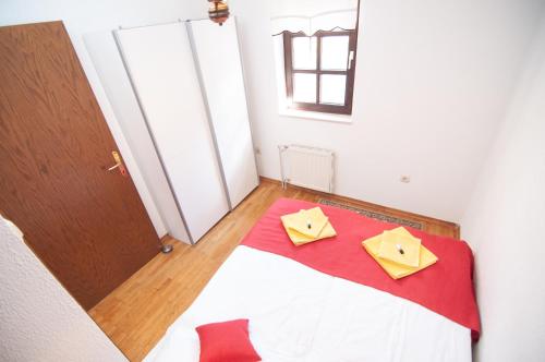 a bedroom with a bed with two yellow boxes on it at Guest house Vila Korošec in Bovec