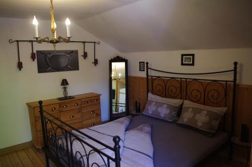 a bedroom with a bed and a dresser at Bed and Breakfast Lucia in Pfronten
