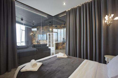 a bedroom with a bed with two towels on it at Gagarin Plaza Luxury Sea View Apartments in Odesa