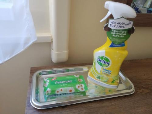 a container of detergent and a bottle of mayonnaise on a counter at Szent Miklós Apartman in Hajdúszoboszló