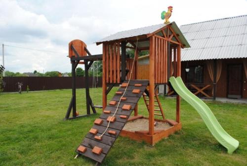 a playground with a slide and a play structure at Сімейний куточок in Svityazʼ