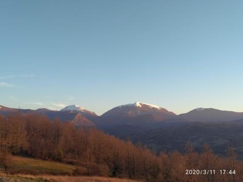 a view of a mountain range with snow capped mountains at I fiori del Pollino - Guest House in San Severino Lucano
