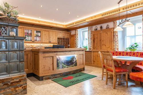 a kitchen with a large fireplace and a table and chairs at Landhaus Santner - Örglwirt's Ferienwelt in Mariapfarr