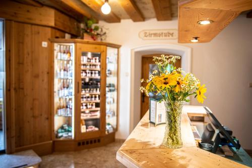 a vase of yellow flowers on a counter in a store at Landhaus Santner - Örglwirt's Ferienwelt in Mariapfarr