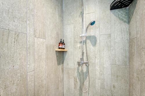 a bathroom with a shower with a shower head at 樹舍包棟民宿開山館 in Tainan