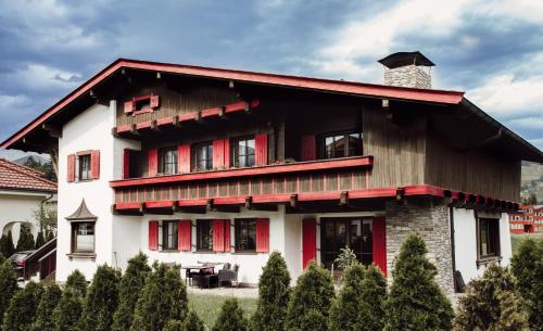 a house with a red and white at Chalet Alpenglück in Reith im Alpbachtal
