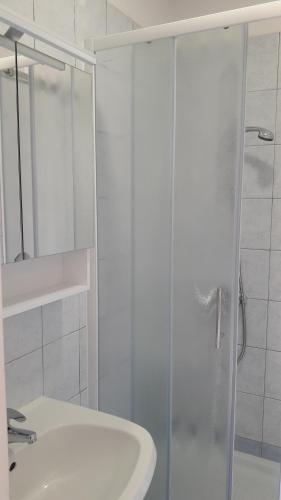 a bathroom with a glass shower and a sink at Rooms Nadia3 in Baška