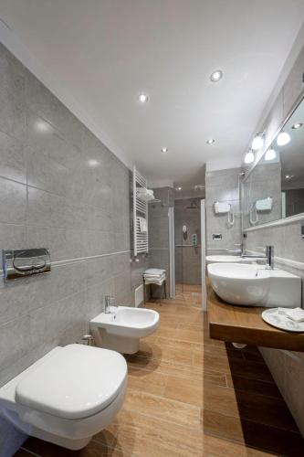 a bathroom with two sinks and two toilets at Hotel Elena in Saint Vincent