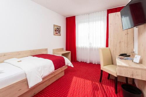 Giường trong phòng chung tại Hanse Hotel