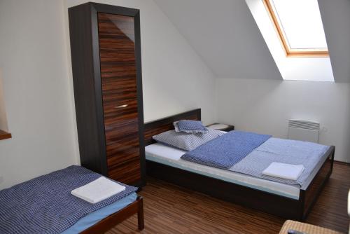 a small bedroom with a bed and a mirror at Harmony Hall in Hradec Králové