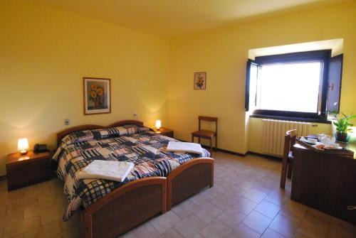a bedroom with a bed and a window at Villa Santa Maria dell'Arco - Centro Oreb in Cazzago San Martino