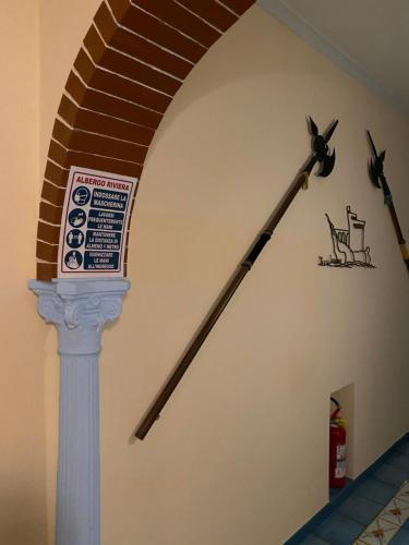 a spiral staircase with a clock on the wall at Riviera B&B Rooms in Maiori