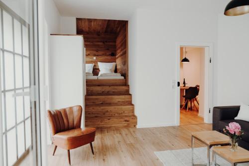 a living room with a stairway leading to a bedroom at Ferienwohnung Alte Wäscherei in Kitzingen