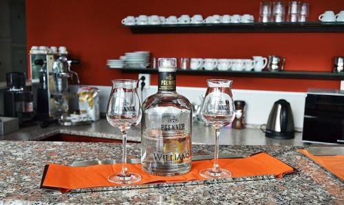 two wine glasses sitting on top of a counter at Motel Vega in Sezimovo Ústí