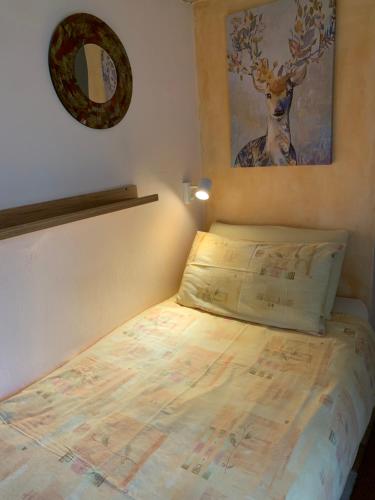 a bed in a bedroom with a picture of a deer on the wall at Bed and Room Al Fiume Piovego in Padova