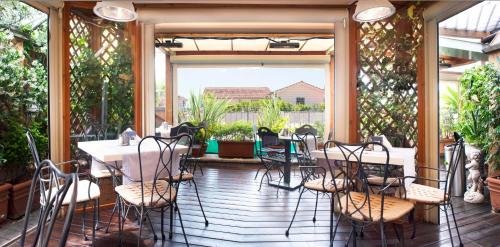 a patio with tables and chairs on a porch at Hotel Scalinata Di Spagna in Rome