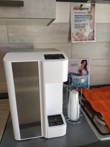a white coffee maker sitting on top of a counter at R&B mediterraneo in Bosa