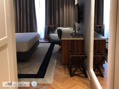 a hotel room with a bed and a desk at Pacheca The Wine House Hotel e Spa - Quinta da Pacheca in Lamego