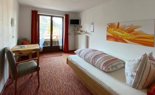 a room with a couch and a table and a desk at Landhaus Nagelfluh in Oberstaufen