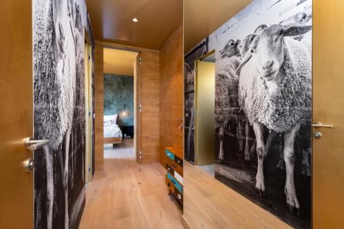 a hallway with a door with a picture of a sheep on the wall at Oblík Resort in Louny
