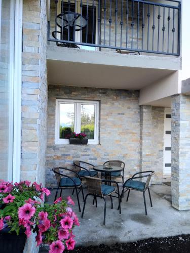 a patio with chairs and a table and a window at Villa Bozovic in Zlatibor
