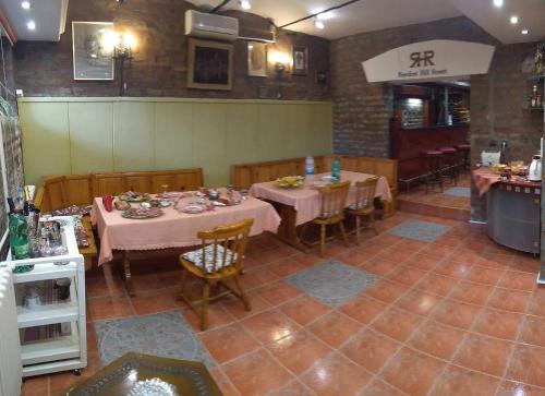 a dining room with tables and chairs in a restaurant at Resident hill resort in Belgrade