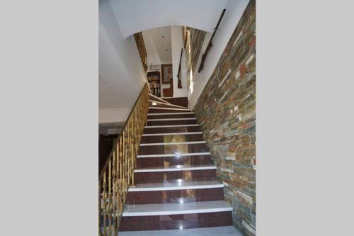 a stairway with a brick wall and a stair case at Seafront Maisonette in Kardamyli in Kardamili