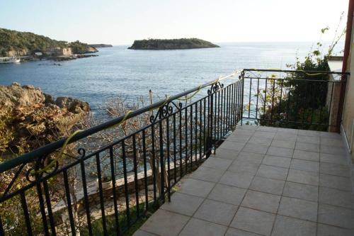 a balcony with a view of a body of water at Seafront Maisonette in Kardamyli in Kardamili