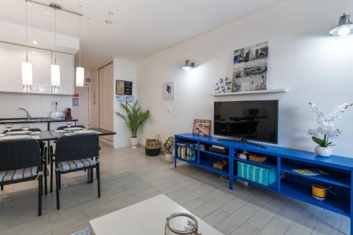 a large kitchen with a blue entertainment center at Serenity by the Marina, Vilamoura in Quarteira