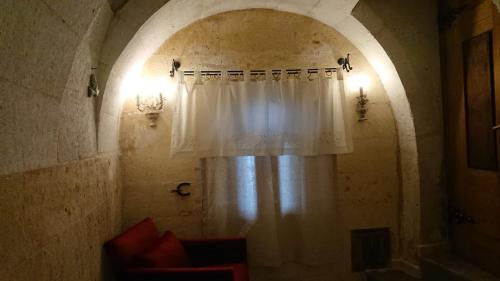a room with a window with a white curtain at Pigeon Hotel Cappadocia in Uchisar