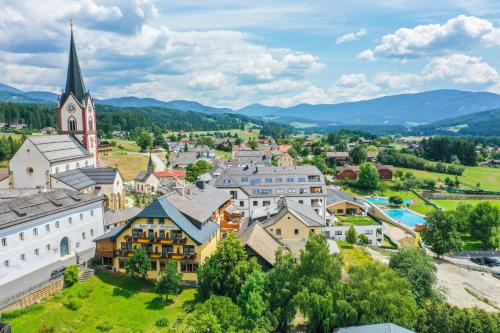 an aerial view of a small town with a church at Landhaus Santner - Örglwirt's Ferienwelt in Mariapfarr