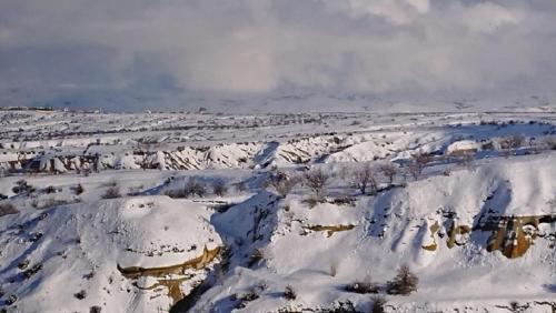 an aerial view of a snow covered field at Pigeon Hotel Cappadocia in Uchisar