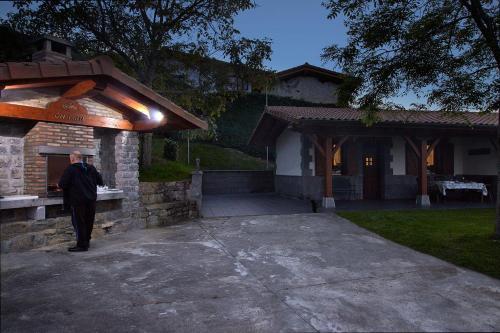 a man standing in front of a building at Epotx Etxea in Getaria