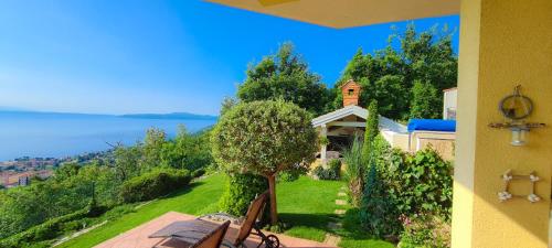 a house with a view of the water at Apartments Villa Krasa in Lovran