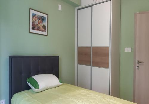 a bedroom with a bed and a glass closet at Lux Apartment in the city center in Štip