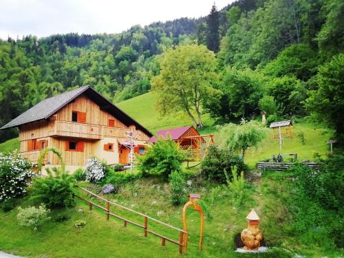 a barn on the side of a hill with trees at Počitniška hiška Kašta in Luče